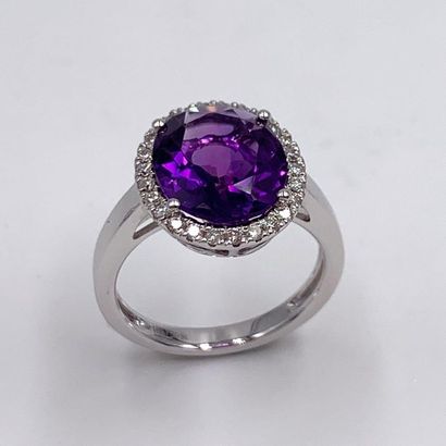 null RING in white gold (750‰) set with an oval amethyst surrounded by brilliant-cut...