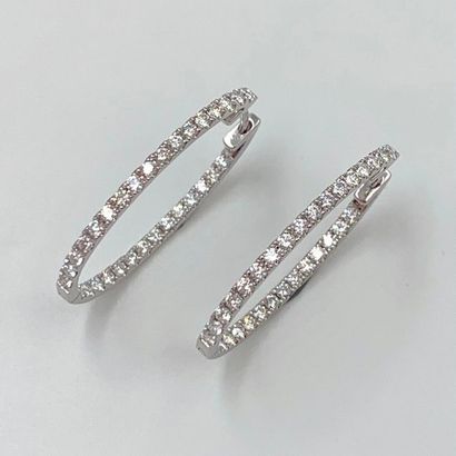 null Pair of "Creole" EARRINGS in white gold (750‰) set with an alignment of 62 brilliant-cut...