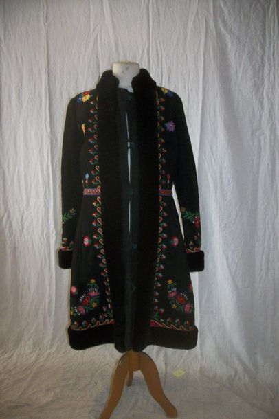 null Coat in turned over skin, Poland, black background, polychrome embroidered decoration...