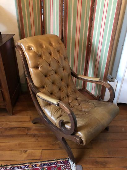 null Wooden reading armchair with leather upholstered seat in Chesterfield style...