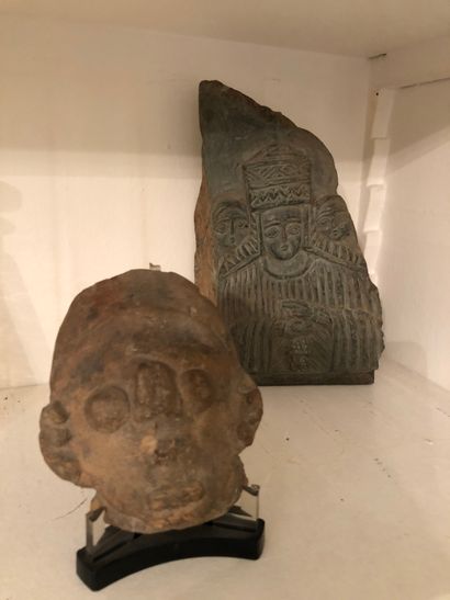 null Lot including a terracotta head and a fragment of stone with carved decorat...