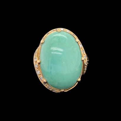 null A yellow gold (750‰) godronné ring, set with an oval-shaped green turquoise...