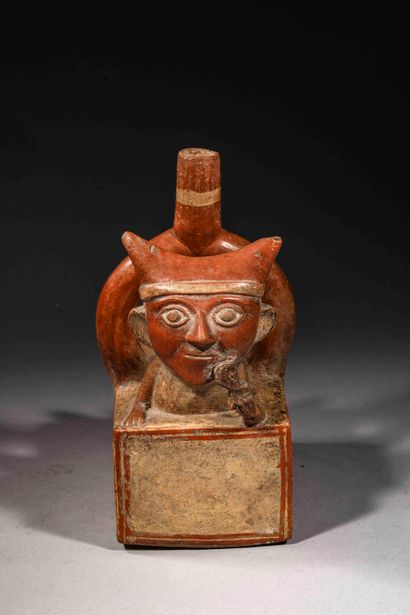 null Vase with stirrup handle representing a character lying on his stomach.

His...