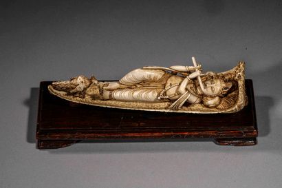 null Carved ivory sculpture representing a woman lying down playing the flute. 

Length...