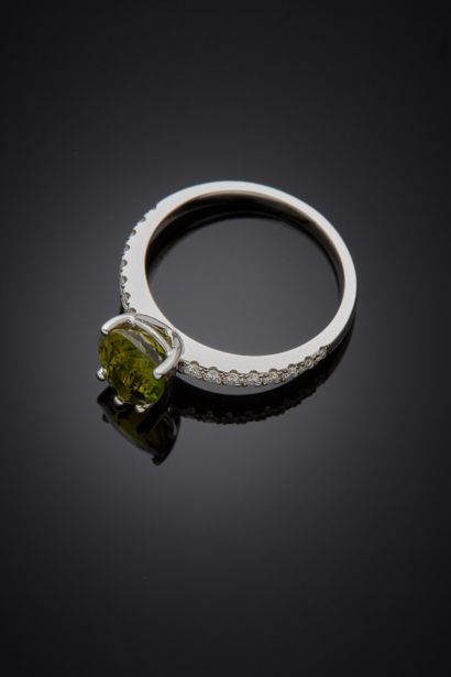 null A white gold (750‰) ring set with a pear-cut green tourmaline, weighing 1.68...