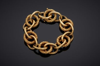  Important yellow gold (750‰) openwork BRACELET with partially chased oval and circular...
