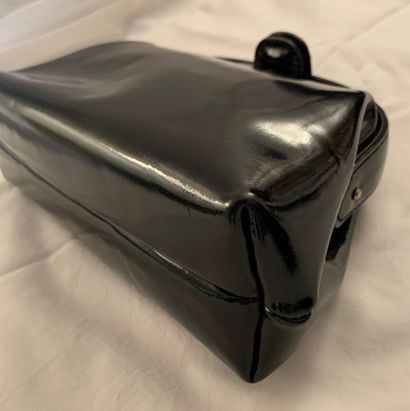 null PIROVANO, Milan

Stirrup" handbag in black patent leather. Golden logo on the...