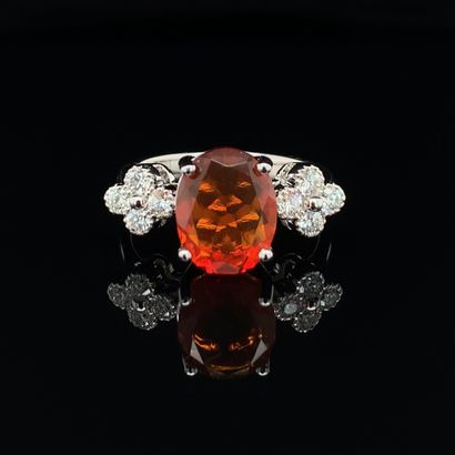 null White gold (750‰) ring set with an oval-shaped fire opal, shouldered by eight...