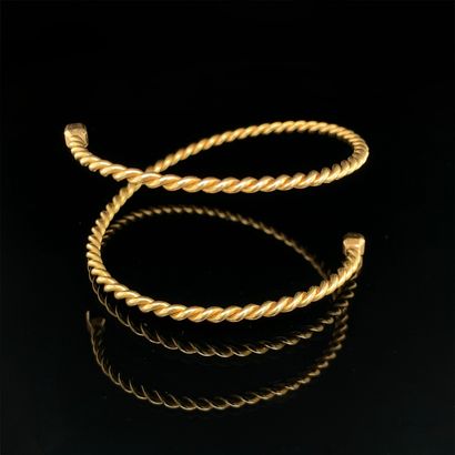 null Two yellow gold (750‰) twisted child's "snake" BRACELETS each finished with...