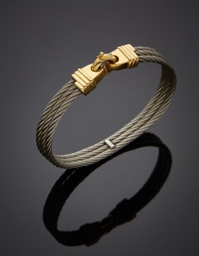 null BRACELET in yellow gold (750‰) godronné, composed of three twisted steel cables....