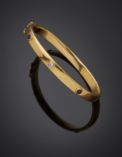 null Yellow gold (750‰) opening rigid BRACELET with three screw motifs, set with...