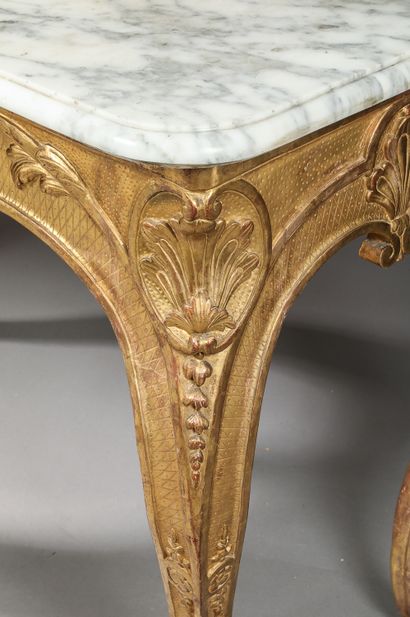 null Rectangular console in carved and gilded wood, the apron decorated in its center...