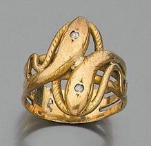 null Large BAGUE «deux serpents» en or jaune (750 millièmes) ajouré et serti de deux...