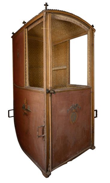 A wooden and leather sedan chair with De...