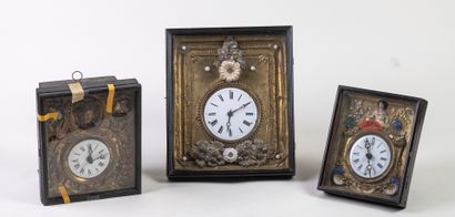 null Suite of three clocks in repoussé brass and polychrome earthenware