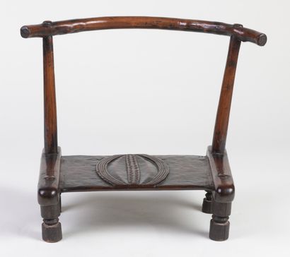 null A man's chair with a seat carved with high relief decorations. Beautiful brown...