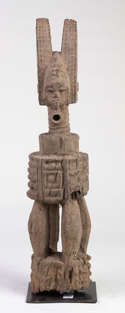 null Ikenga" altar representing an ancestor smoking a pipe. These protective sculptures...