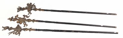  Set of three ceremonial spears with blackened wooden shafts ending in dragon heads...