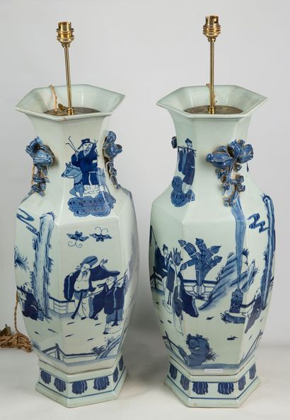 null Pair of blue and white lamps of octagonal shape with cut peacocks and character...