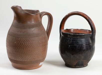  A set of six pieces including a geometrically decorated pourer, a dark brown glazed...