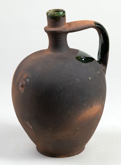 null Terracotta jug with green glaze in Pré d'Auge, H : 28cm
