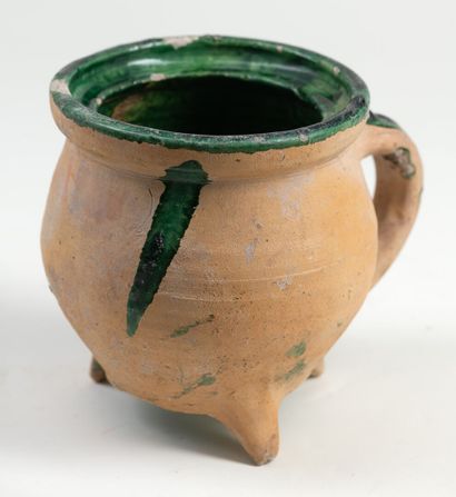 Trypode jug in terra cotta and green glaze...