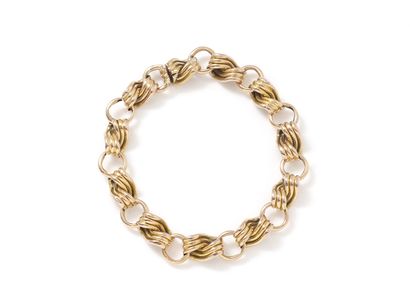 null Gold bracelet 750 thousandths, composed of godronné links alternated with rings....