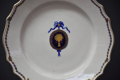 null Plate in Tournai porcelain with floral decoration in a blue and gold medallion....
