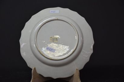 null Plate in Tournai porcelain with floral decoration in a blue and gold medallion....