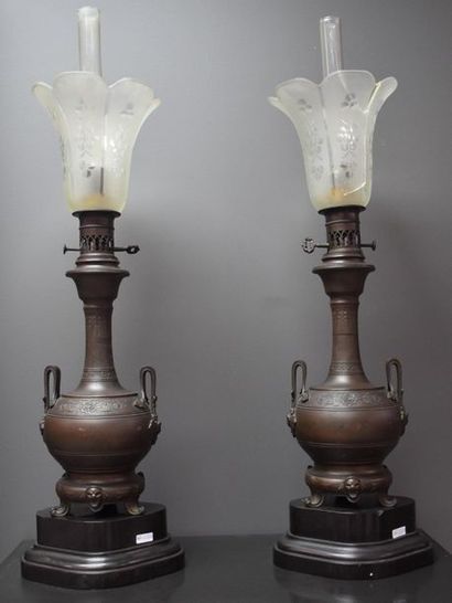 Pair of bronze lamps on black marble base....