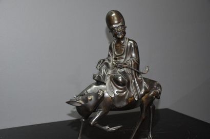null Asian bronze sculpture monk on a buffalo. Ht 36 cm.