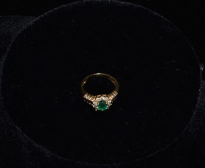 null Ring in 18 k yellow gold set with a 0.7 k emerald with small diamonds . Weight...