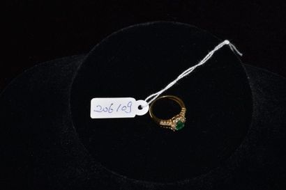 null Ring in 18 k yellow gold set with a 0.7 k emerald with small diamonds . Weight...