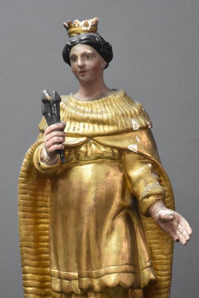 null Saint holding the nails of the crucifixion. Carved gilded and polychromed wood.

18th...