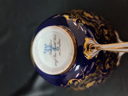 null Chocolate cup and its saucer in Meissen porcelain on a blue and gold background...