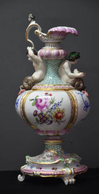 null Meissen porcelain ewer with tritons decoration supporting a handle ending with...
