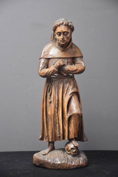 null Sculpture en bois XVIIIème représentant un moine posant le pied sur un crâne....