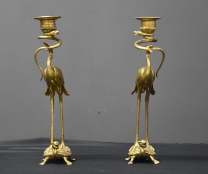 null Pair of bronze candlesticks in the Japanese style. Stilt walkers on top of turtles....