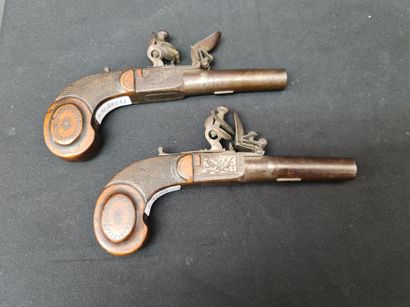 null Pair of small flintlock pistols. Crosses decorated with spirals. Small engravings...