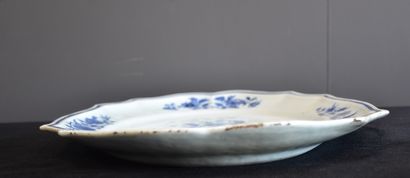 null A Chinese porcelain oval and scalloped dish with white and blue decorations....