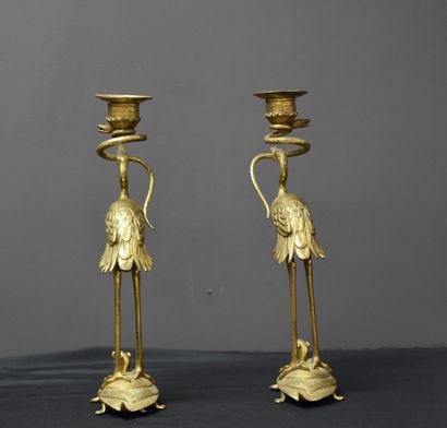 null Pair of bronze candlesticks in the Japanese style. Stilt walkers on top of turtles....