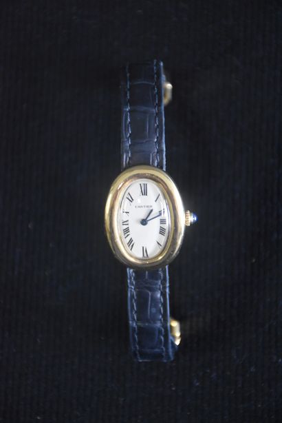 null Cartier lady's gold watch with leather strap, bathtub model. Accompanied by...