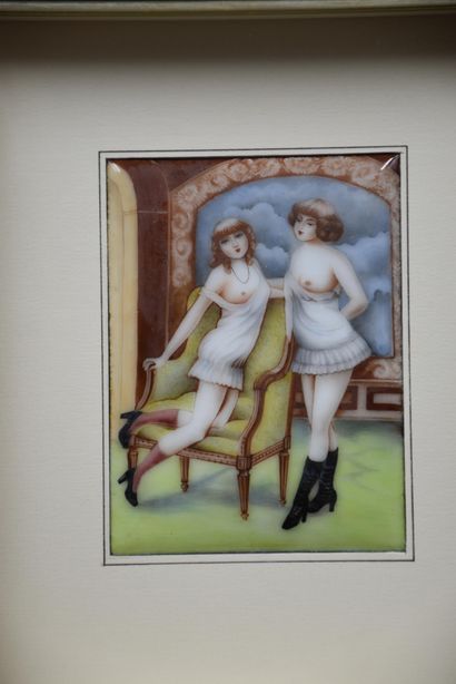 null An art nouveau enamelled plate decorated with an erotic scene of two ladies...