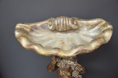 null Venetian planter in carved and silvered wood representing a cherub with a shell....