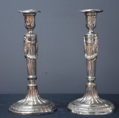 null 一对路易十六时期的银质火把，上面装饰着花环，带有1774年安特卫普市的标记。一个底座略微歪斜，两个火把中的一个在轴上有一个小洞。