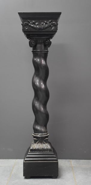 A black twisted marble column, carved with...