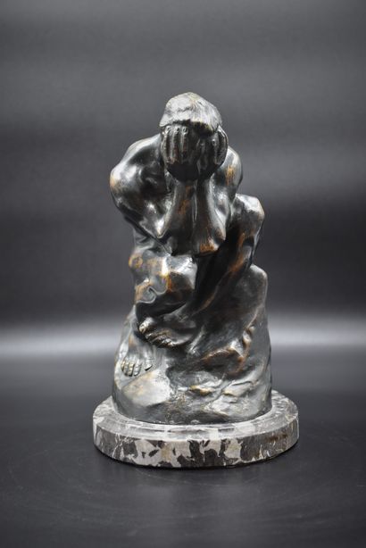 
Bronze figure holding his head in his hands.

Work...
