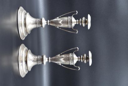 null A pair of silver candlesticks. 19th century. Height : 30 cm.