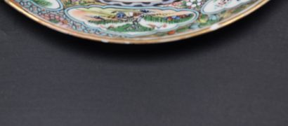 null 
A Chinese porcelain plate, decorated with many characters. 19th century. A...
