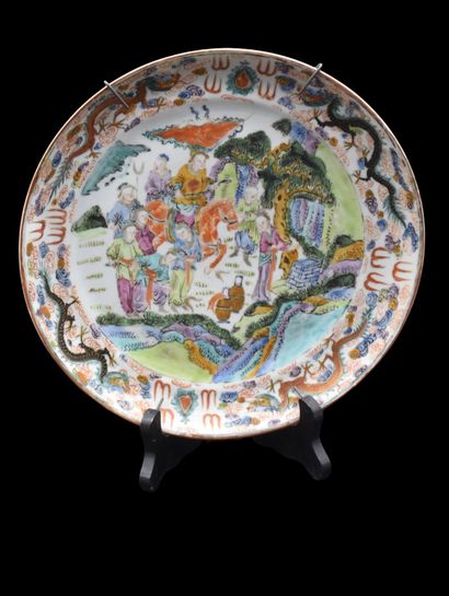 null 
A Chinese porcelain plate, decorated with many characters. 19th century. A...
